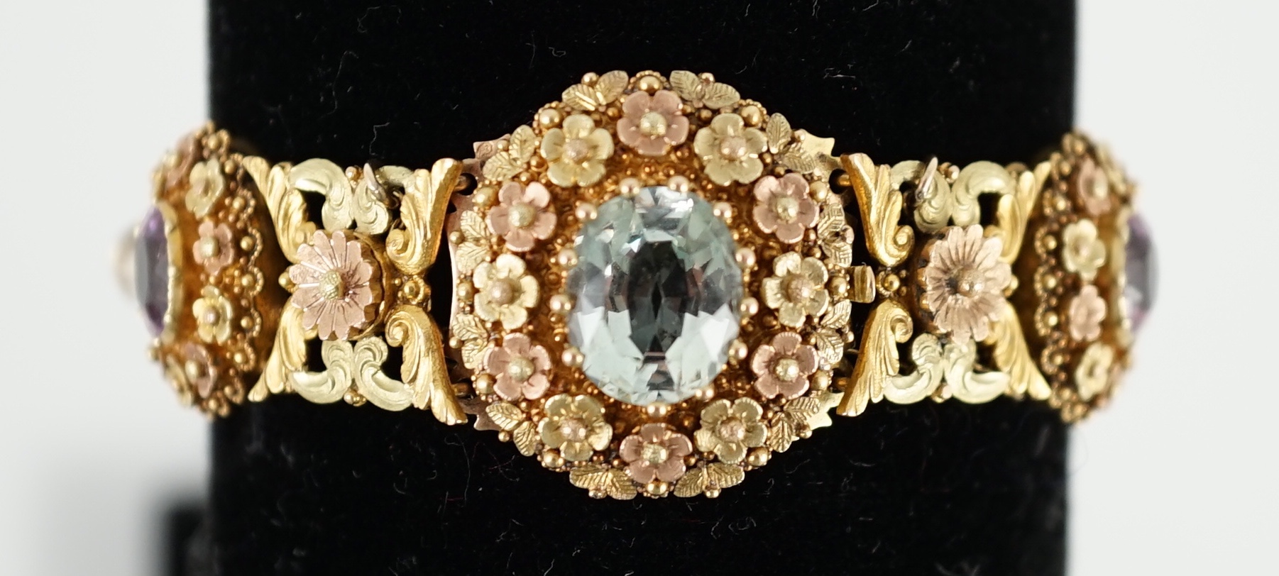 A 19th century pierced three colour gold, pink topaz, moonstone, citrine and aquamarine set bracelet.